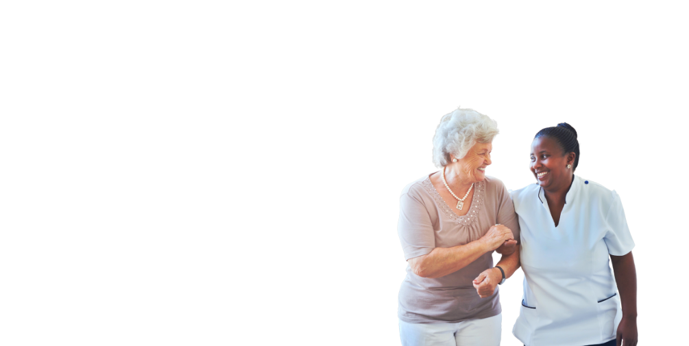 Caregiver and an elder woman smiling at each other