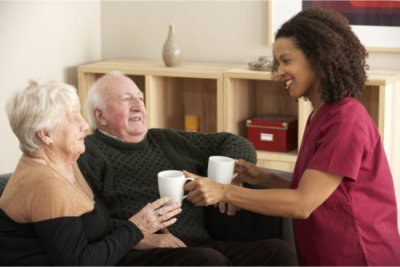 nurse visiting senior couple at home