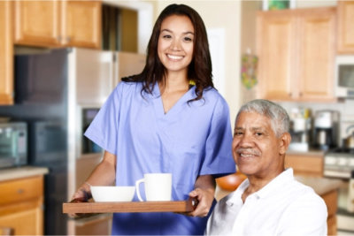 caregiver helping an elder man